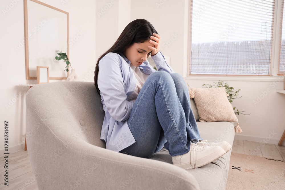 Young woman feeling unwell on sofa at home Young woman feeling unwell on sofa at home