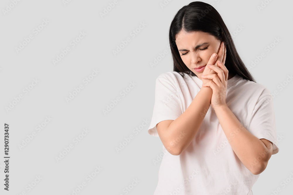 Young woman suffering from toothache on white background Young woman suffering from toothache on white background