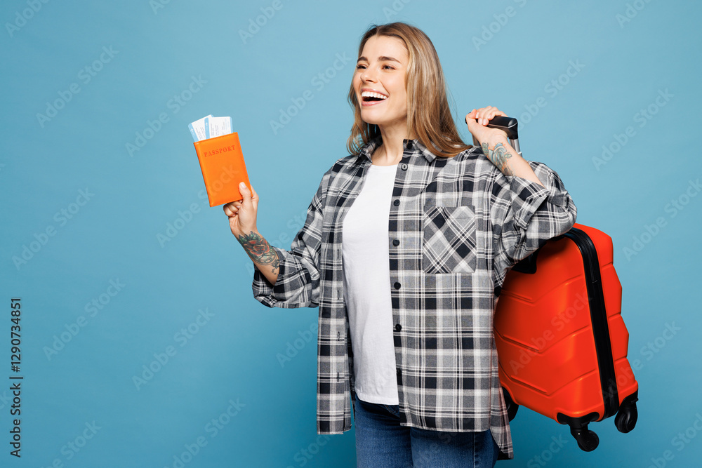 Traveler woman wear grey casual clothes hold passport ticket bag look aside isolated on plain blue background. Tourist travel abroad in free spare time rest getaway. Air flight trip journey concept.