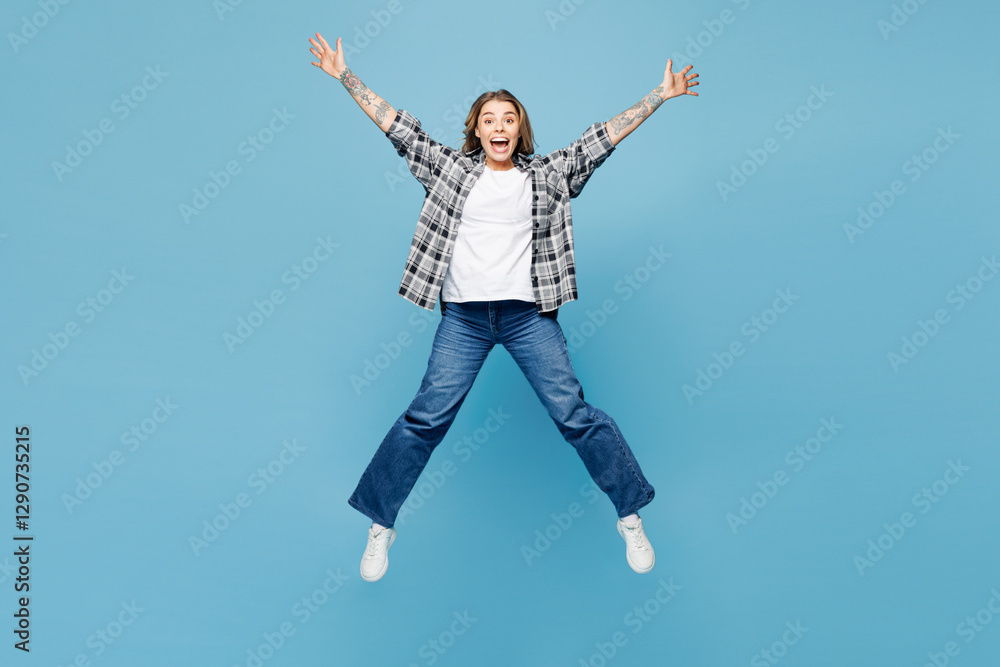 Full body young shocked surprised woman wears checkered grey shirt casual clothes jump high with outstretched hands legs isolated on plain pastel light blue cyan background studio. Lifestyle concept. Full body young shocked surprised woman wears checkered grey shirt casual clothes jump high with outstretched hands legs isolated on plain pastel light blue cyan background studio. Lifestyle concept.