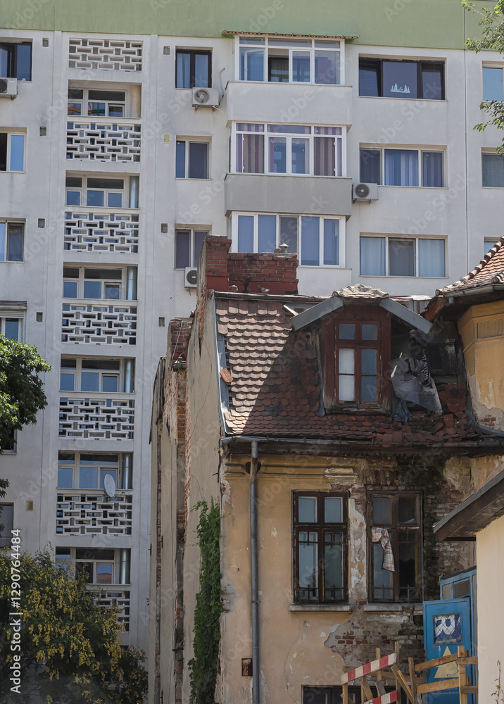 Naklejka premium Contrast between historical architecture and modern buildings in Bucharest Romania highlights urban development struggles