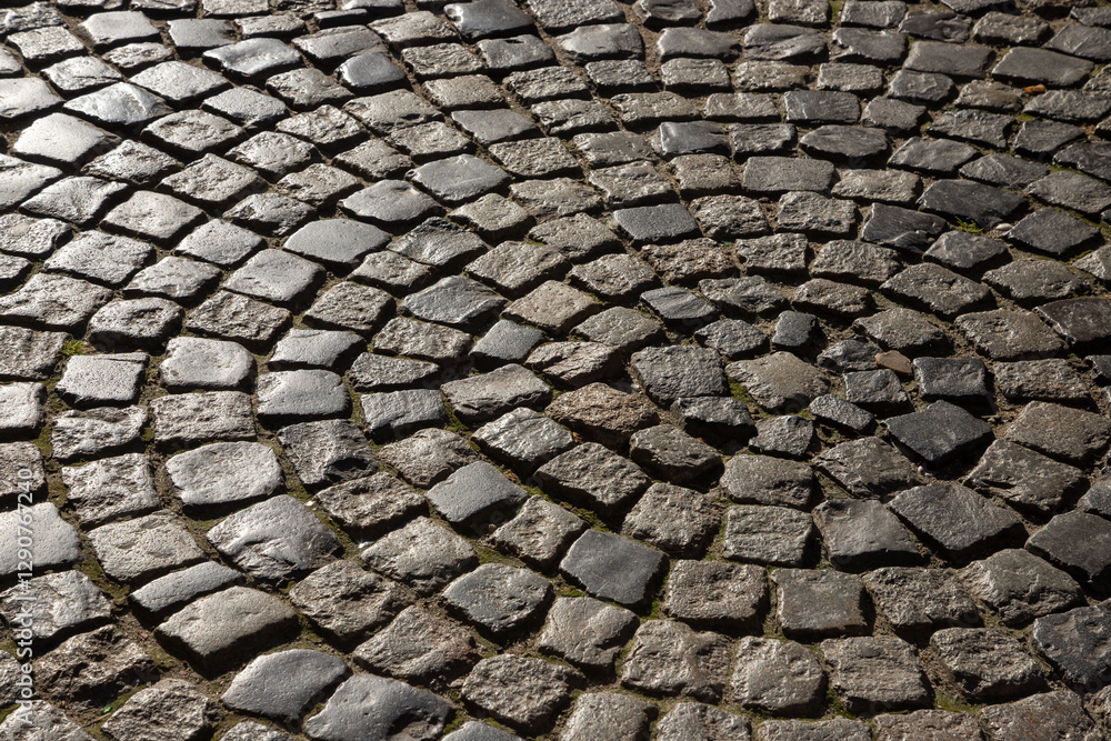 Unique spiral formation of cobblestones in an ancient street creates an artistic view showcasing intricate patterns and textures under soft lighting conditions Unique spiral formation of cobblestones in an ancient street creates an artistic view showcasing intricate patterns and textures under soft lighting conditions