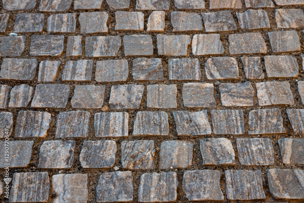Obraz premium Cobblestone streets in Bucharest reflect the city's historic charm and unique architecture, inviting visitors to explore the vibrant culture of Romania