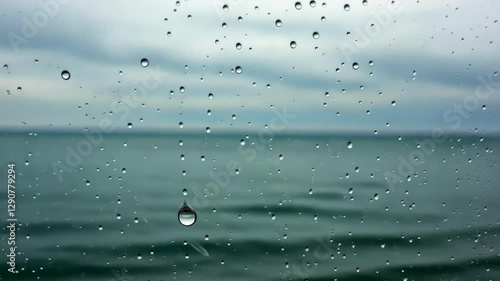 Wallpaper Mural Raindrops on a window overlooking a calm sea under a cloudy sky Torontodigital.ca