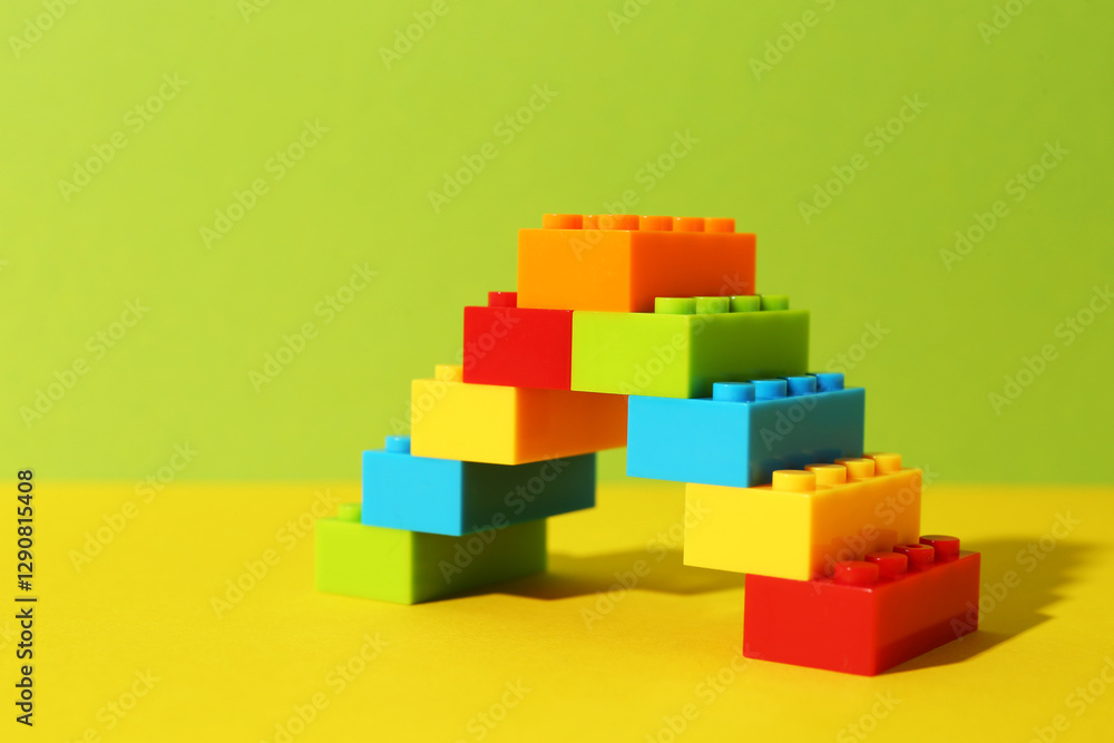 Fototapeta premium Construction toy. Figure made with building bricks on color background