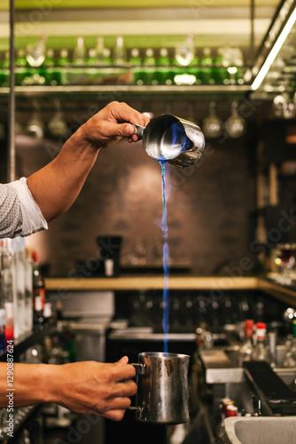 Bartender Skillfully Pouring Flaming Cocktail in Bar Setting photo