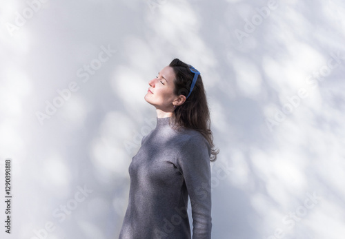 Woman enjoying a peaceful spring walk in nature and against a wall photo