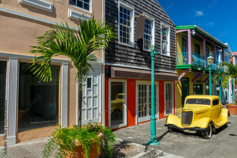 Vintage car and old houses in Old street, colorful cityscape in Philipsburg, Caribbean travel, Sint Maarten island (Saint Martin), Dutch West Indies