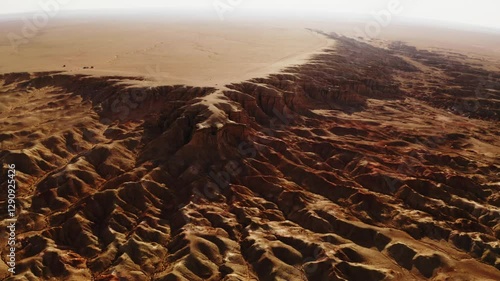 Aerial drone footage of Tsagaan Suvarga, Mongolia's Mars-like landscapes, showcasing stunning cliffs and desert terrain glowing at sunset.