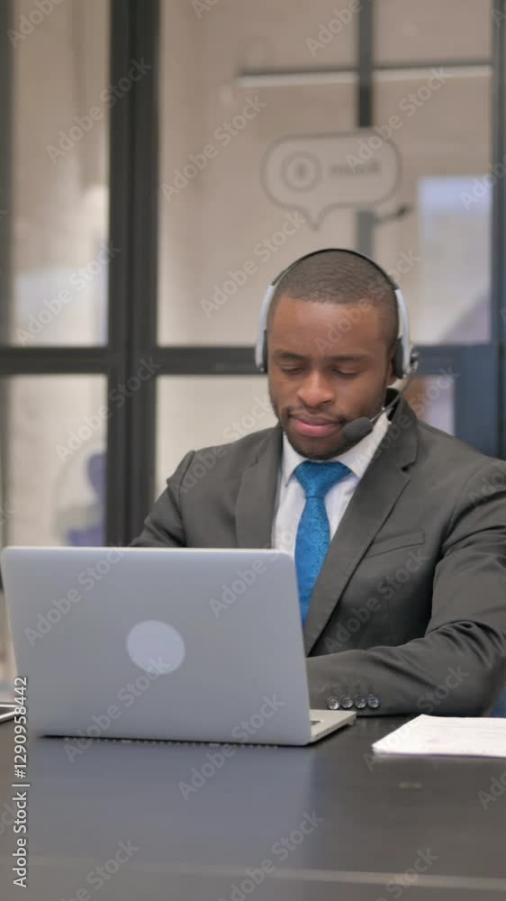 Thumbs Up by African Businessman with Headset Using Laptop Thumbs Up by African Businessman with Headset Using Laptop