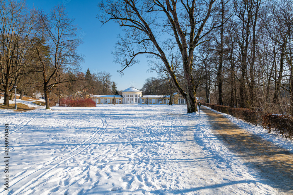 Small colonnade in Marianske Lazne (Marienbad) - snow winter in spa park. Spa architecture - colonnade of cold mineral water spring Ferdinand - Czech Republic, Europe