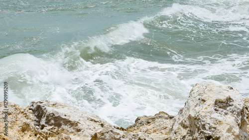 BALI, INDONESIA - JANUARY 22, 2018: Rocks and the Indian Ocean powerful crushing waves near Pandawa Beach, Bali. photo