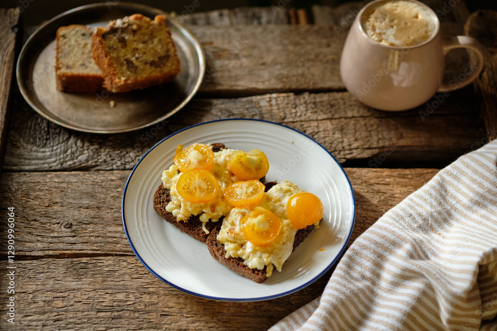 rye bread toast with scrambled eggs and yellow cherry tomatoes rye bread toast with scrambled eggs and yellow cherry tomatoes