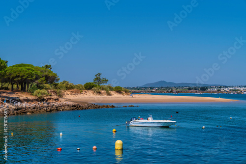Tavira Island beach and boat on north side view to Tavira town Algarve Portugal with blue sea