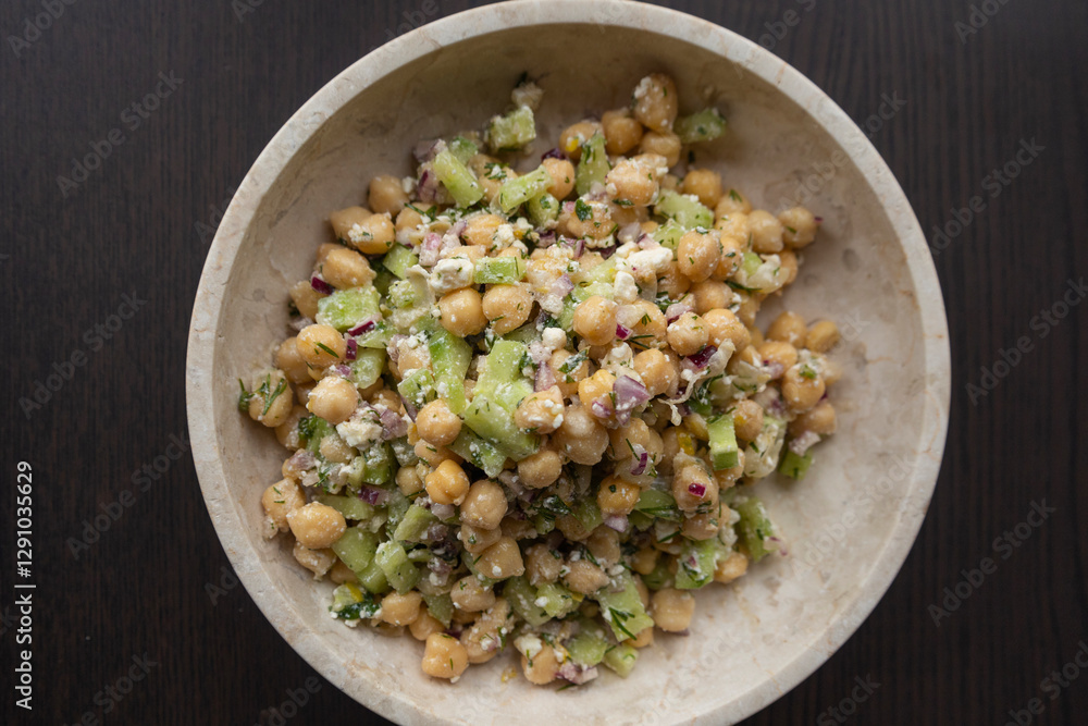 delicious healthy salad with chickpeas, cucumber, and feta cheese close-up delicious healthy salad with chickpeas, cucumber, and feta cheese close-up