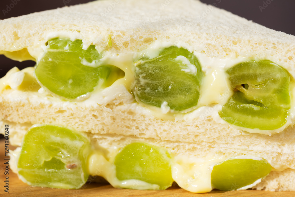 Korean sandwich with green grape and cream cheese, closeup. Hard light. Asian dessert, street food. Korean sandwich with green grape and cream cheese, closeup. Hard light. Asian dessert, street food.