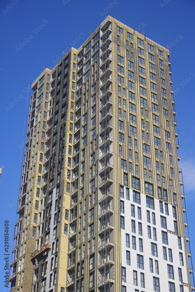 construction cradle on the facade of a building under construction, new building in a residential area, sunny day, Moscow, February 2025, 2 construction cradle on the facade of a building under construction, new building in a residential area, sunny day, Moscow, February 2025, 2