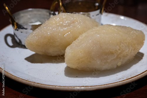 Obraz na płótnie Large potato dumplings called Cepelinai - one of the dishes of traditional lithuanian cuisine. Also known in Poland and called Cepeliny or Kartacze w salonie