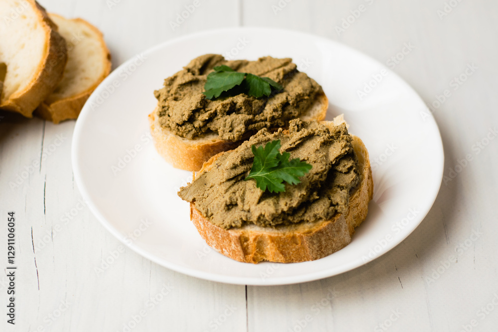 Healthy food, sandwiches with liver pate and a baguette with a crispy crust on a light background