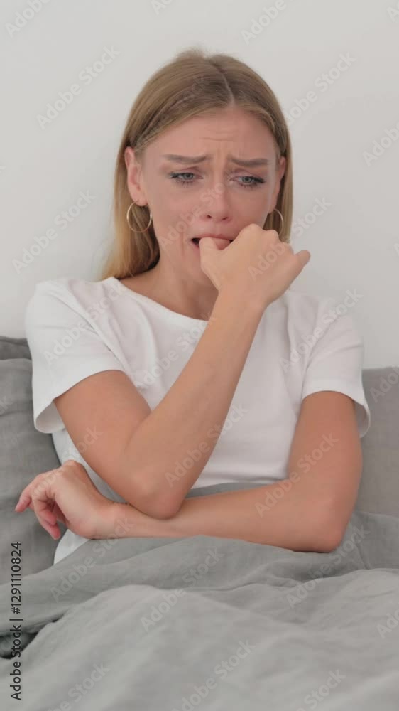 Crying Young Woman Sitting on Side of Bed Crying Young Woman Sitting on Side of Bed