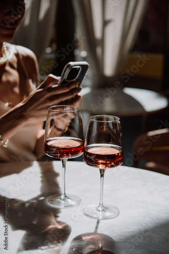 Obraz na płótnie Glasses of rose wine seen during a friendly party or a celebration in a restaurant of a bar. w salonie