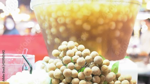 Longan fruit in blender container of sweet logan juice in street food market.
