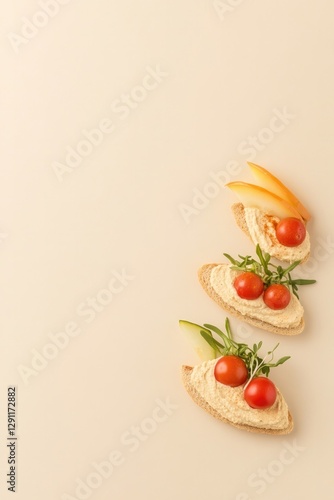Fresh bread slices topped with cherry tomatoes and herbs on ligh