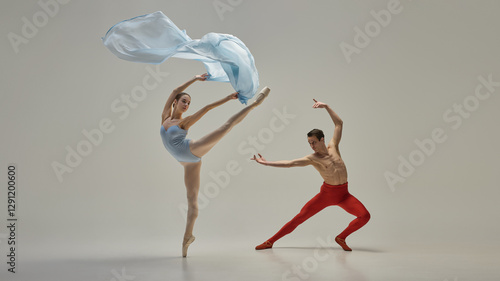 Young artistic ballet dancers performing dynamic pose with fluid and expressive movement against minimal background. Concept of grace, beauty, balance, partnership, rhythm, elegance, motion.