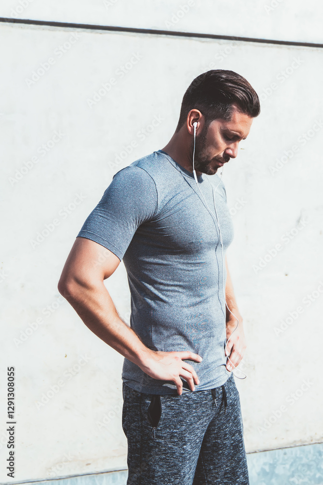 Calm sportsman relaxing after workout exercise in street Calm sportsman relaxing after workout exercise in street