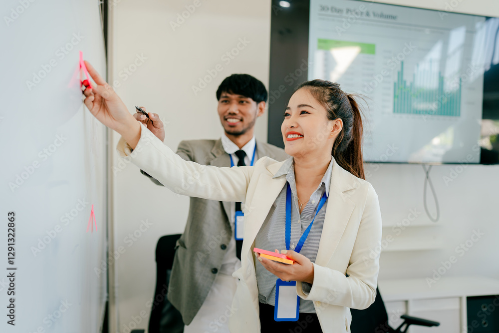 Fototapeta premium Woman and a man are drawing on a whiteboard