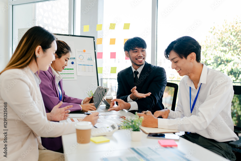 Group of people are sitting around a table, some of them smiling Group of people are sitting around a table, some of them smiling