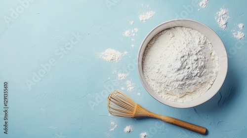 Bowl full of fresh flour next to a brightly whisked mixture, ready for baking delicious pastries