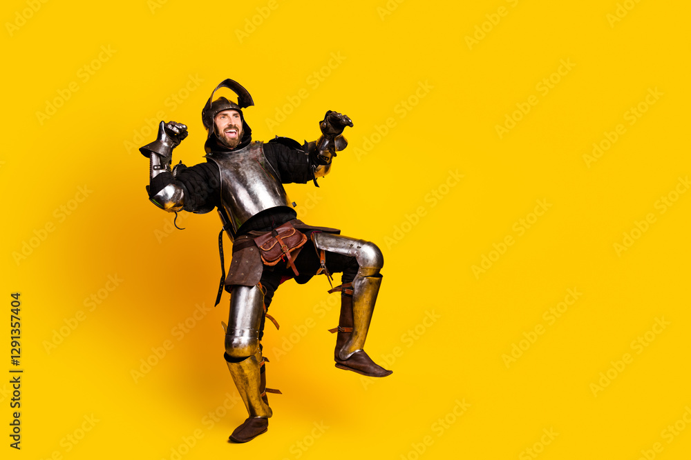 Humorous portrayal of a young man in knight's armor against a vibrant yellow backdrop Humorous portrayal of a young man in knight's armor against a vibrant yellow backdrop