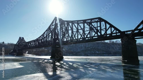 train bridge in winter over frozen river