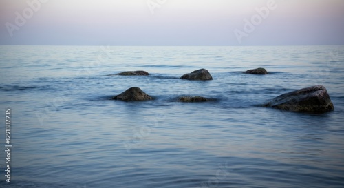 Wallpaper Mural Tranquil seascape with smooth water and scattered rocks at sunset Torontodigital.ca