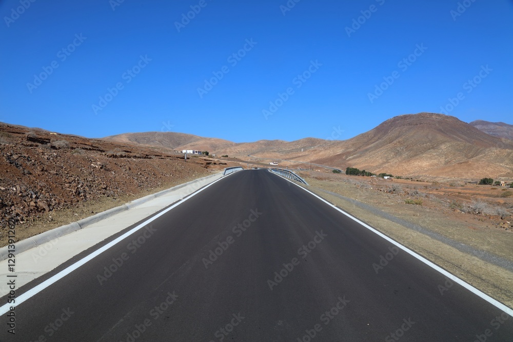 Freshly repaved asphalt mountain road in Fuerteventura Freshly repaved asphalt mountain road in Fuerteventura