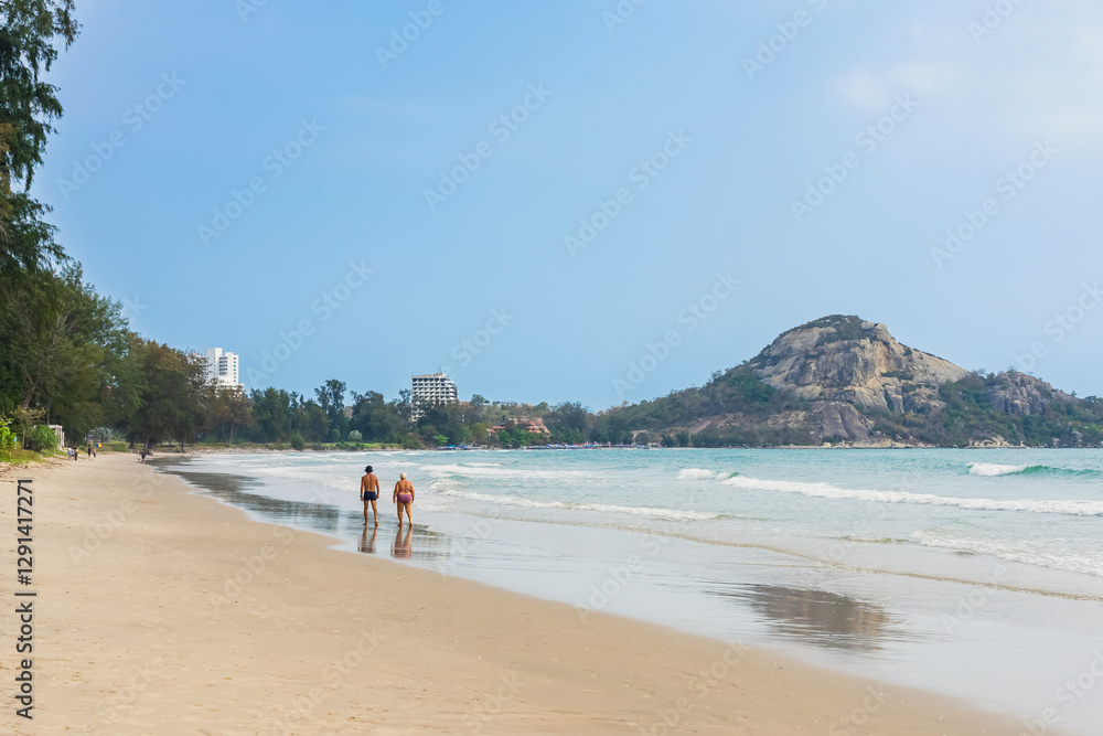 Back view of senior lovers walking together on beach. Portrait elderly couple while walking along the beach, concept of senior lifestyle, travel, relaxing in nature. Family walk on coastline at beach. Back view of senior lovers walking together on beach. Portrait elderly couple while walking along the beach, concept of senior lifestyle, travel, relaxing in nature. Family walk on coastline at beach.