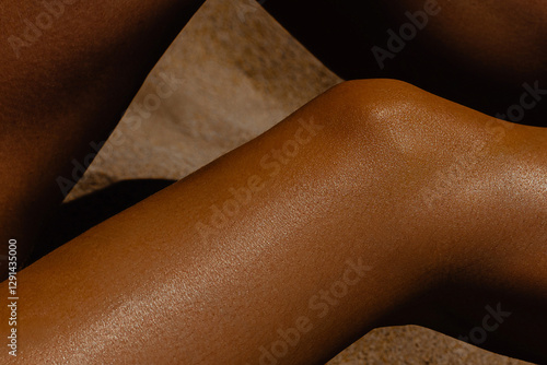 Cuadro en lienzo Close-up of sun-kissed female skin in sunlight on sand background