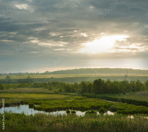 Tranquil countryside under cloudy sky, wetlands, river floodplain of Seret Ri...