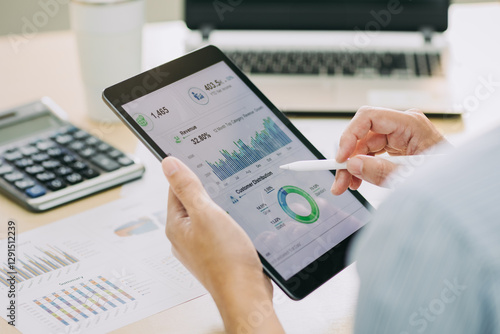 Businessman working on project for analyzing company financial report balance statement with dashboard at modern office space. Concept of business economy and marketing result.