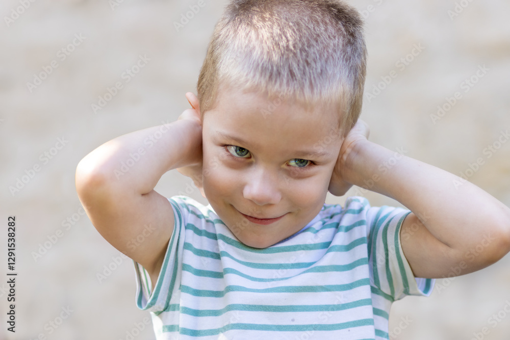 Little boy covers his ears with his hands Little boy covers his ears with his hands