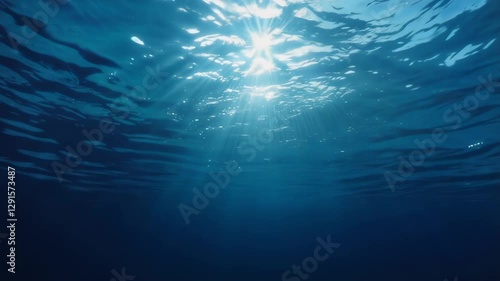 Underwater deep blue ocean background with ripple, wave lights, and sun rays, copy space