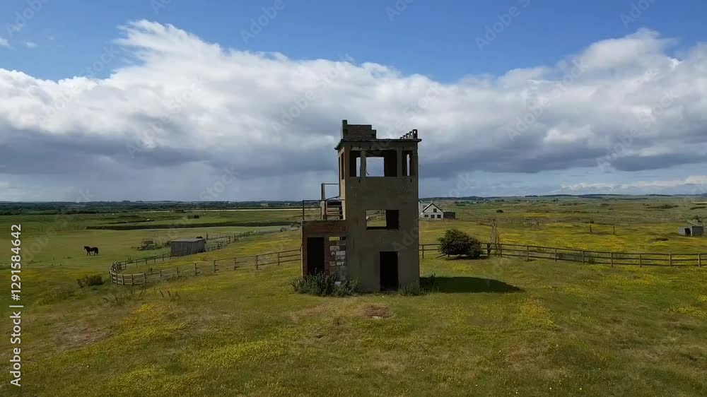 drone flying above a Lookout tower in vast green field at Ball's Point in the countryside of Ireland drone flying above a Lookout tower in vast green field at Ball's Point in the countryside of Ireland