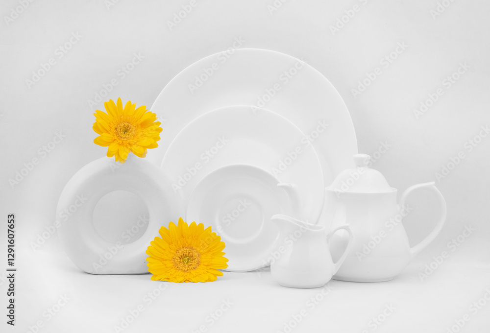 Still life utensils and crockeries in white on a white background.