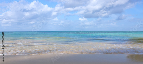 Tropical paradise beach with white sand and blue sky.