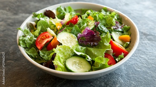 A bowl of salad: Describe the fresh, crisp greens, colorful vegetables, and the tangy dressing that ties it all together.