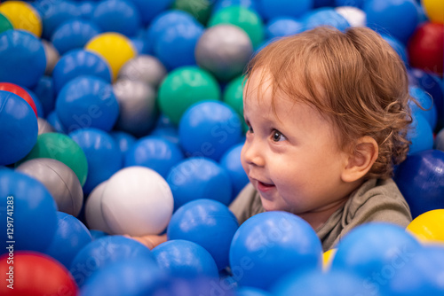 Baby sitting in a ball pit