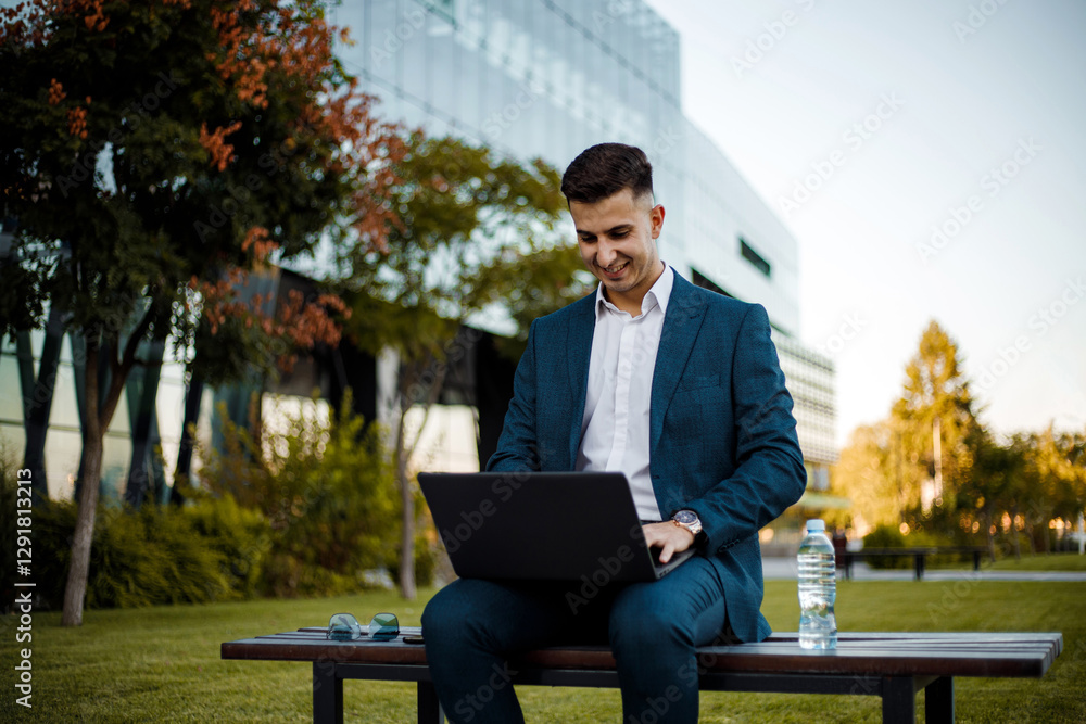 Man Sitting on a Bench Using a Laptop Man Sitting on a Bench Using a Laptop