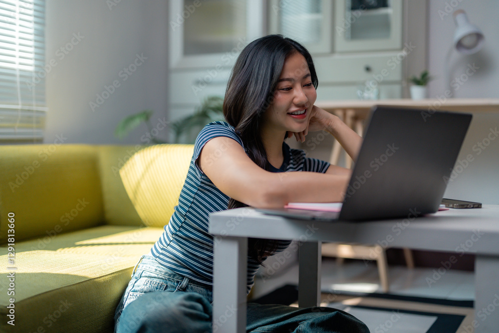 Naklejka premium Young Asian Woman Working From Home Using Laptop Computer