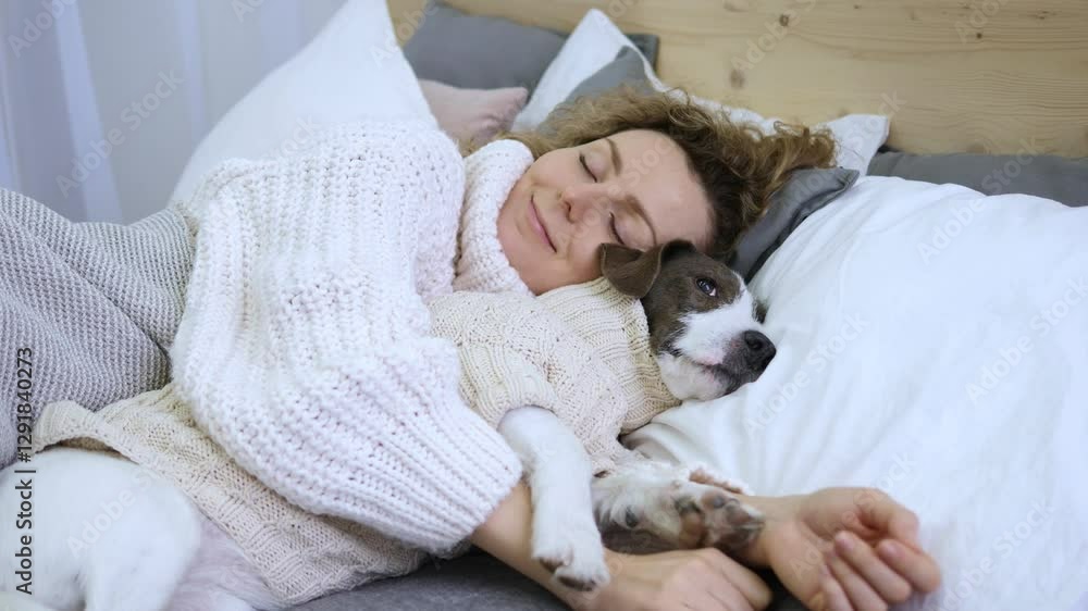 Owner and faithful dog sleep in embrace on spacious bed. Both wearing cozy sweaters. Owner gently hugs pet, creating touching scene. Bond between owner and dog is strong. Peaceful sleep in warm arms. Owner and faithful dog sleep in embrace on spacious bed. Both wearing cozy sweaters. Owner gently hugs pet, creating touching scene. Bond between owner and dog is strong. Peaceful sleep in warm arms.